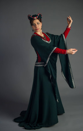 beautiful young girl in a historical dress on gray backgroundの写真素材