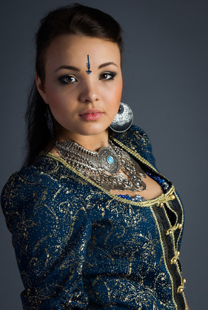 beautiful young girl in a historical dress on gray backgroundの写真素材