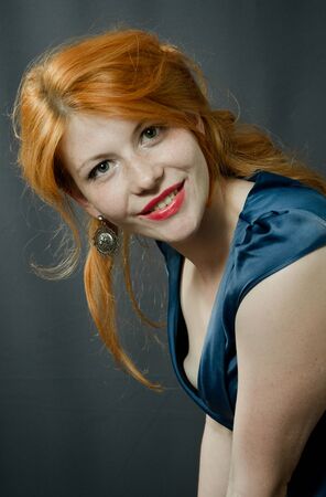 beautiful red-haired girl in a blue dress. Pin-up.の写真素材