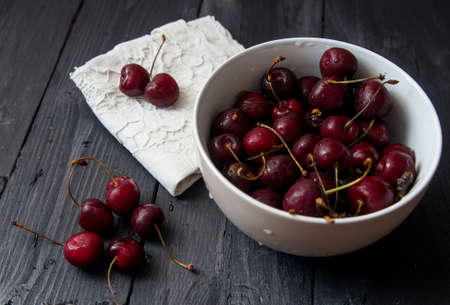 some fresh ripe red cherries on black tableの写真素材