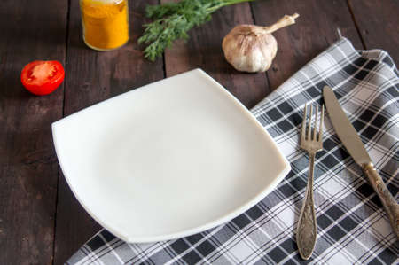 square white plate on a vintage woodrn tableの写真素材