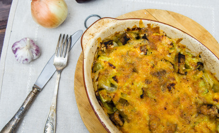 zucchini and eggplant baked with cheese in a clay baking dishの写真素材