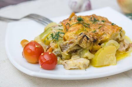 zucchini and eggplant baked with cheese on white plate