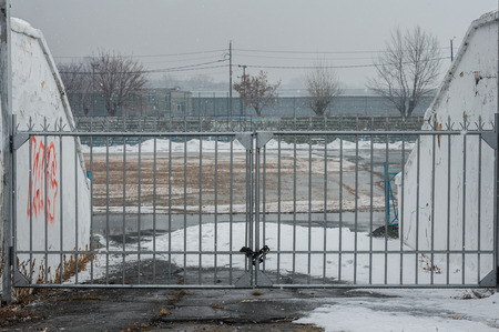 closed gates of a sports stadium at snowing day.