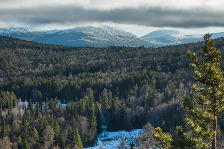 snow-capped peaks of Mount Iremel over the autumn forestの写真素材