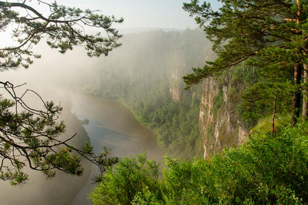 The morning mist rises over the river canyon. Landscapeの写真素材