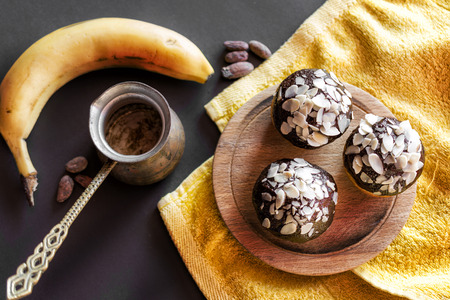 Vanilla cupcakes with chocolate frosting and sliced almondsの写真素材