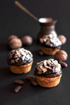 Vanilla cupcakes with chocolate frosting and sliced almondsの写真素材