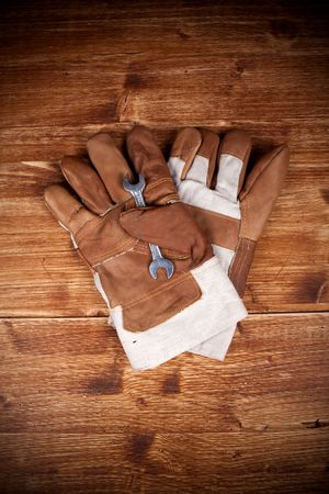 Two Glove And Screw Key on Vintage Wood Backgorundの写真素材