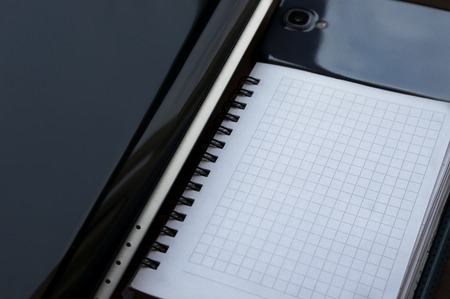 Image of necessary business attributes consisting of laptop, desk organizer and smartphone
