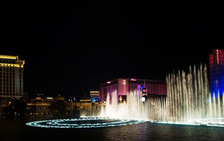 LAS VEGAS - MAY 2:Musical fountains of Bellagio Hotel on Flamingo Casino background, May 2, 2007.のeditorial素材