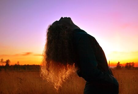 Girl on the sunset background 