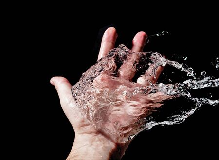 Hand and splashing water の写真素材