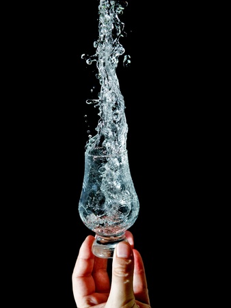 The stream of water pours into the glass の写真素材