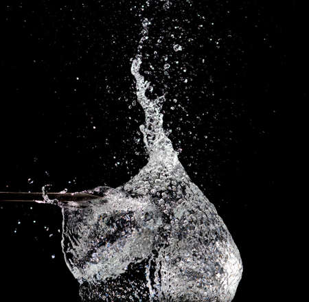 Splash of water on black の写真素材