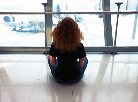 Woman waiting for her flight on airport のeditorial素材