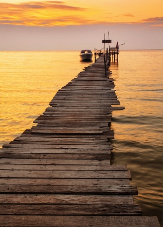 Sunset over the sea. Pier on the foregroundの写真素材