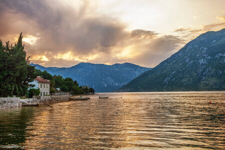  Sunset on the sea with the Ð° foggy mountains  Montenegro