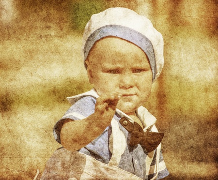 Portrait of a happy blue-eyed child boy in grunge and retro stylesの写真素材