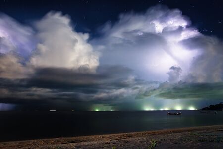 Lightning above the sea in tropical night at the beach.Thailand