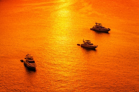 Sailing boats on a background of a beautiful sunset の写真素材