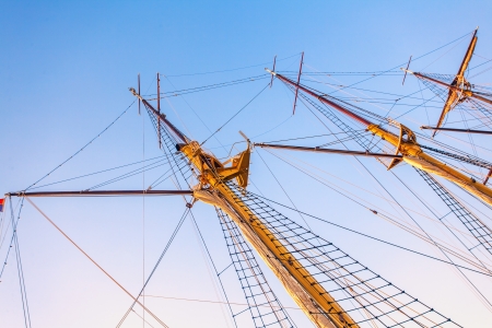 Sailboat masts in sunset light on sky backgroundの写真素材