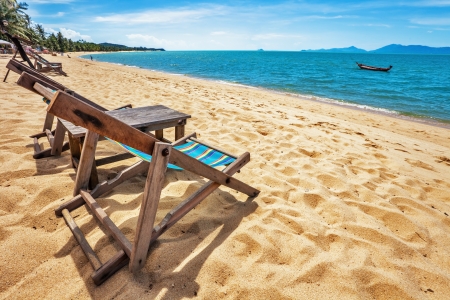 sun beach chairs on shore near sea  Thailand の写真素材