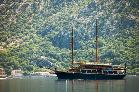 The yacht in the  sea on moutains backgroundの写真素材