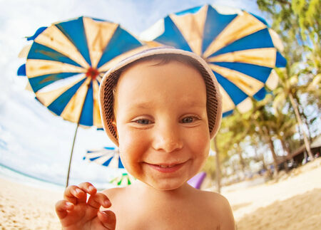 funny boy at the beachの写真素材