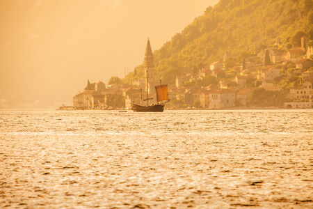 Old sailing ship in the rays of light of the setting sun の写真素材
