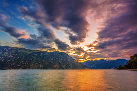 Gloomy sea sunset on mountains 