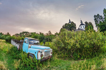Old lorry in the field under gloomy skyの写真素材