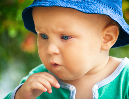 Closeup portrait of cute little funny boy in soft focusの写真素材