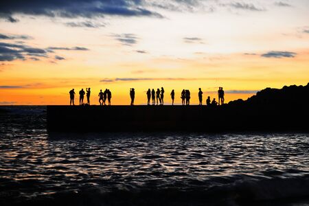 People silhouettes on the sea pier at sunset. Canary Tenerife island. Spainの写真素材