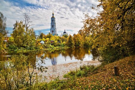 Autumnal landscape with old russian church reflected in the riverの写真素材