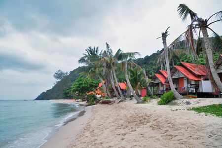 Cheap bungalows for backpackers on a tropical beach in evening time. Thailandの写真素材