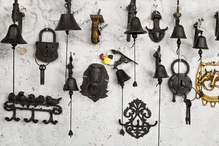 souvenirs on the wall: bells, locks, hangers, knockersの写真素材