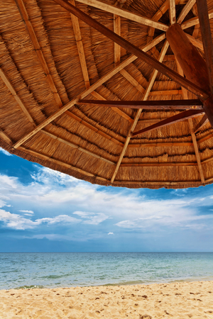 Wooden umbrella on white sand beach at Phu Quoc island in Vietnamの写真素材