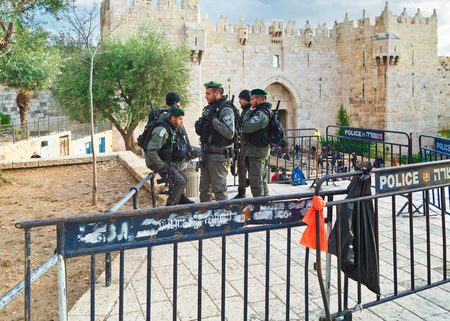 JERUSALEM, ISRAEL - DECEMBER 29, 2016: Police officers are on duty near Damascus Nachem Gate to old city of Jerusalem. They were built in 16th century and are a typical example of Muslim architectureのeditorial素材