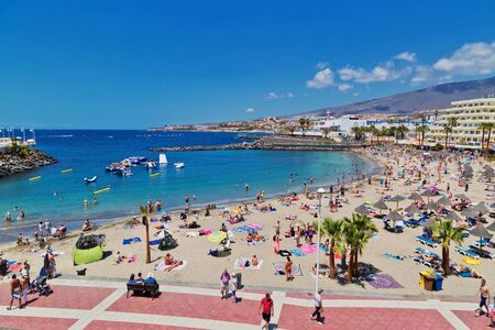TENERIFE ISLAND, SPAIN - APRIL 10, 2017 : Tourists are sunbathing on Colon beach on the Costa Adeje on Tenerife. Canary Islands. Spainのeditorial素材