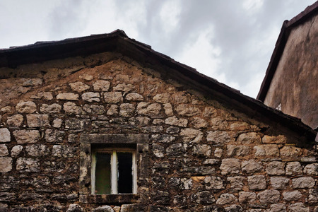 Facade of old building under gloomy sky in ancient European city Kotor in Montenegro. の写真素材
