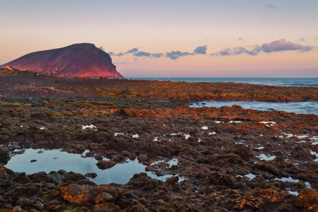 Volcanic stones  beach in sunset time  in Tenerife, Canary Islands, Spain の写真素材
