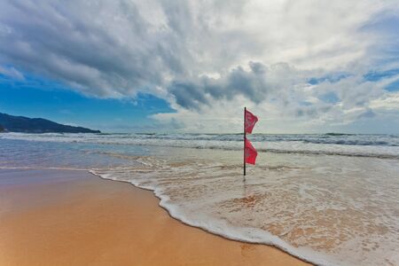 Red warning flag at beach. Phuket, Thailand. の写真素材