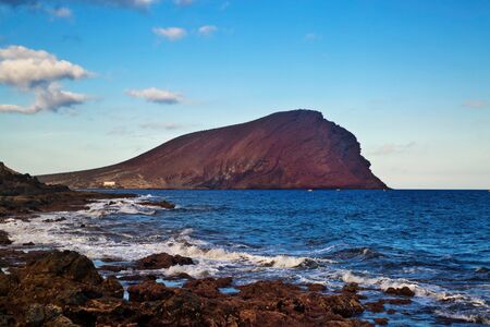 Sunset time at  Playa de la Tejita with red mountain Montana Roja, Tenerife, Spainの写真素材