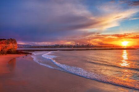 Beautiful seascape with beach, cliffs and ocean. Pintadinho beach. Ferragudo, Lagoa, Algarve, Portugalの写真素材