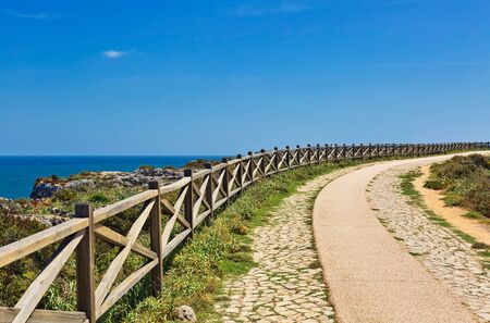 Coast of Algarve, Sagres, Portugal, Europe. Image shows coast of Sagres with hiking trail and wooden balustrade, Algarve, Portugal, Europeの写真素材