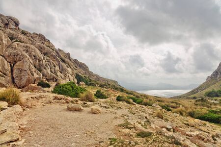 Landscape of rocky coast before a storm under gloomy dramatic sky (cape formentor). Mallorca....