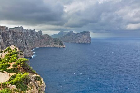 Landscape of rocky coast before a storm under gloomy dramatic sky (cape formentor). Mallorca....