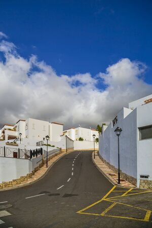 Street with typical Canary style holiday apartments in Costa Adeje, Tenerife, Canary Islandsの写真素材