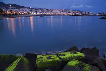 Beautiful night scene over Costa Adeje with colorful lights reflected in the sea in Tenerife, Canary island, Spain. の写真素材